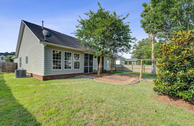 back of property featuring cooling unit, a patio area, and a lawn