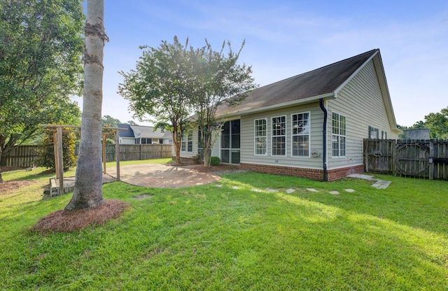 back of property with a patio and a lawn