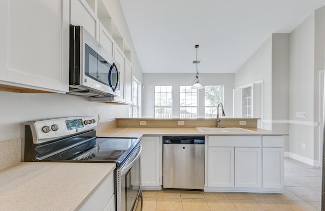 kitchen with decorative light fixtures, white cabinets, stainless steel appliances, and sink