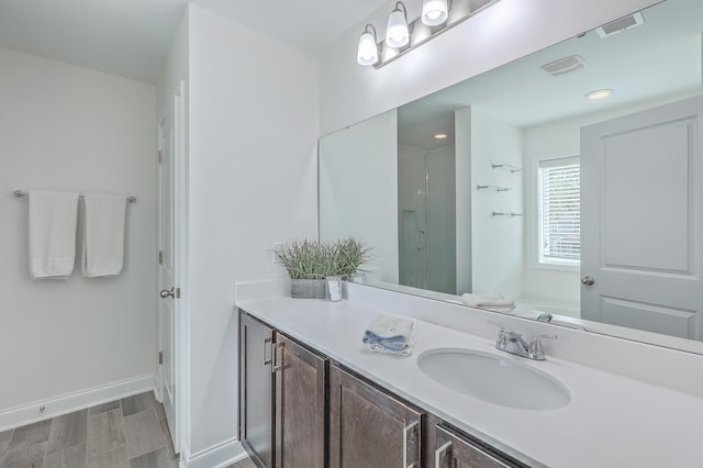 bathroom with vanity and a shower with door