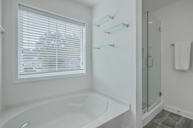 bathroom featuring independent shower and bath