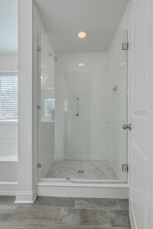 bathroom with a shower with door