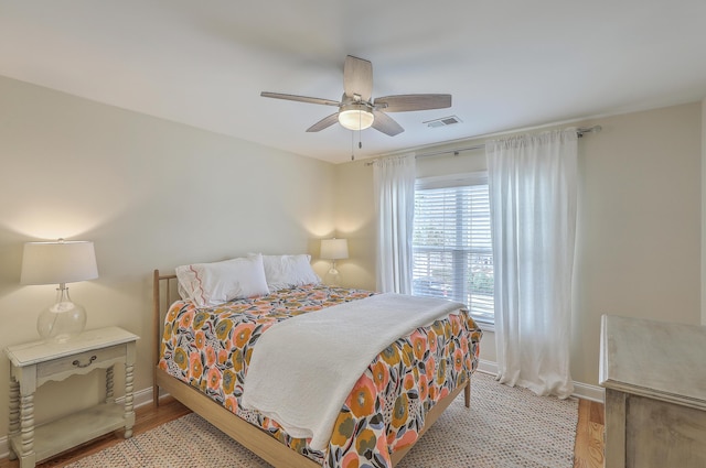 bedroom with ceiling fan and light wood-type flooring