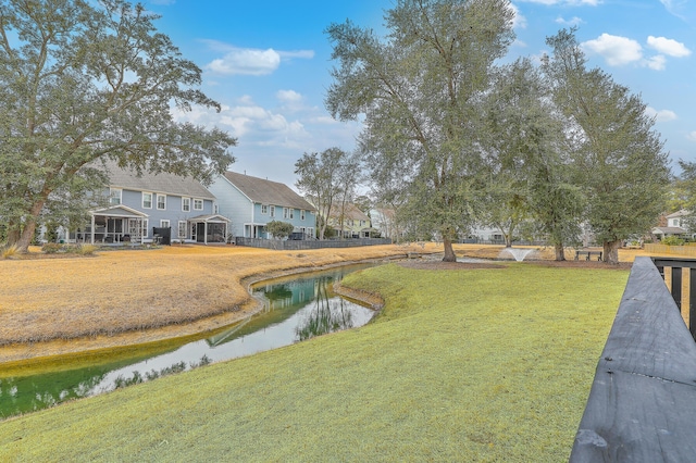 view of yard with a water view and a sunroom