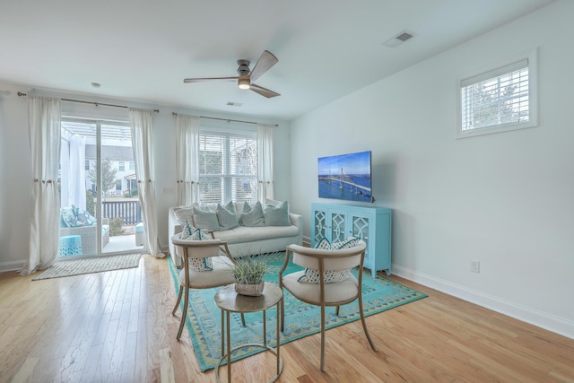 living room with ceiling fan and light wood-type flooring