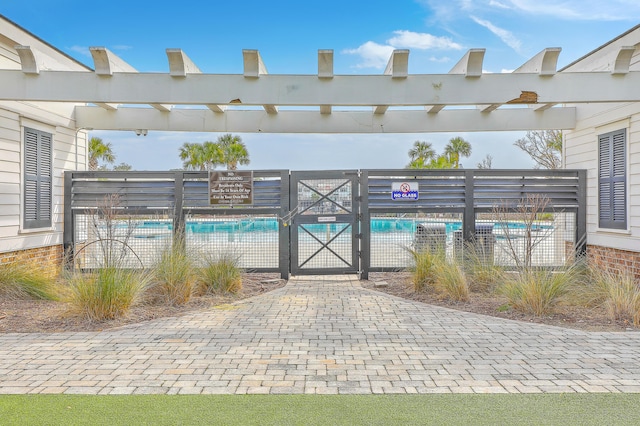 view of gate featuring a community pool