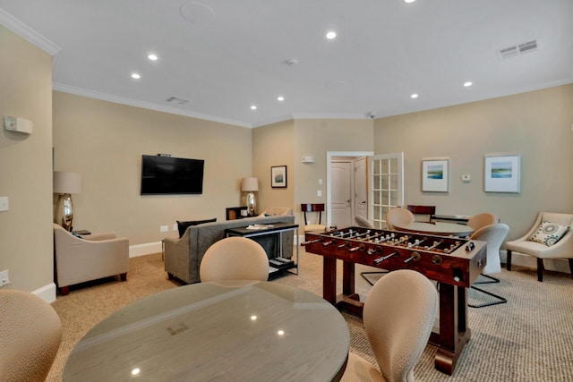 dining room with ornamental molding and light carpet