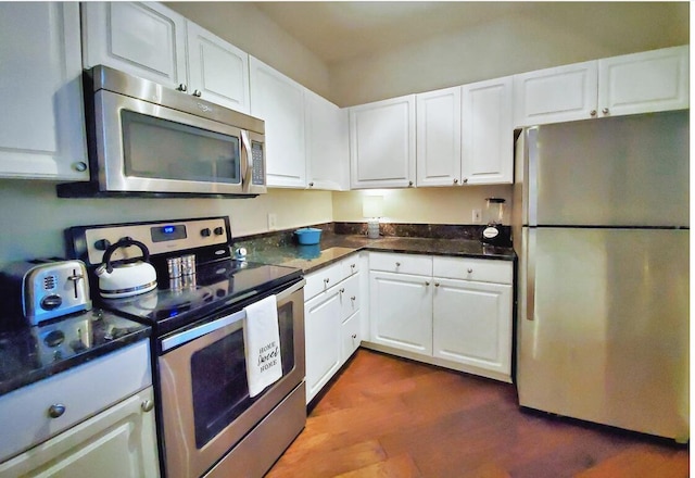 kitchen with white cabinets, dark hardwood / wood-style floors, and stainless steel appliances