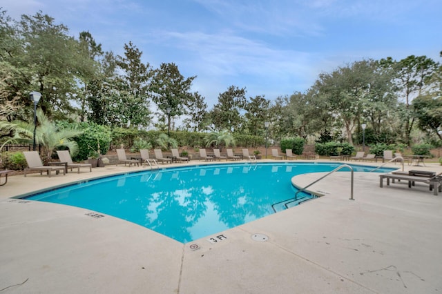 view of swimming pool with a patio