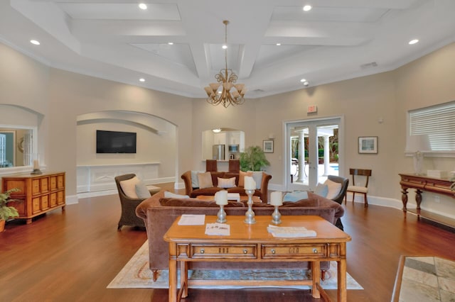 living room featuring beam ceiling, hardwood / wood-style flooring, french doors, and an inviting chandelier