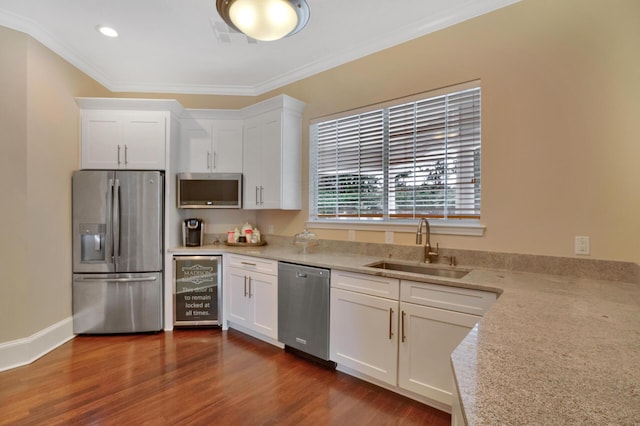 kitchen with sink, stainless steel appliances, and white cabinetry