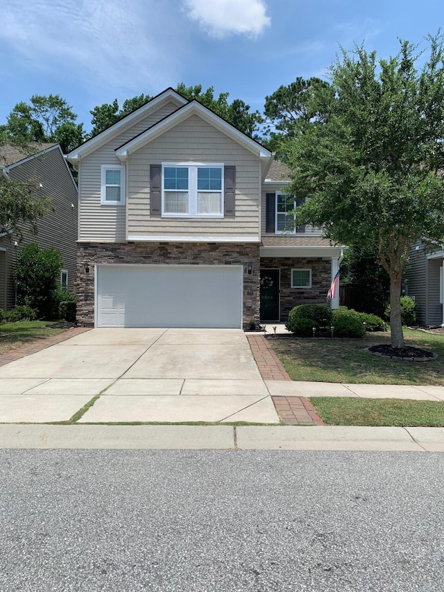 3808 Tupelo Branch Row, Mount Pleasant, SC 29429 - view of front facade with stone siding, a garage, and concrete driveway