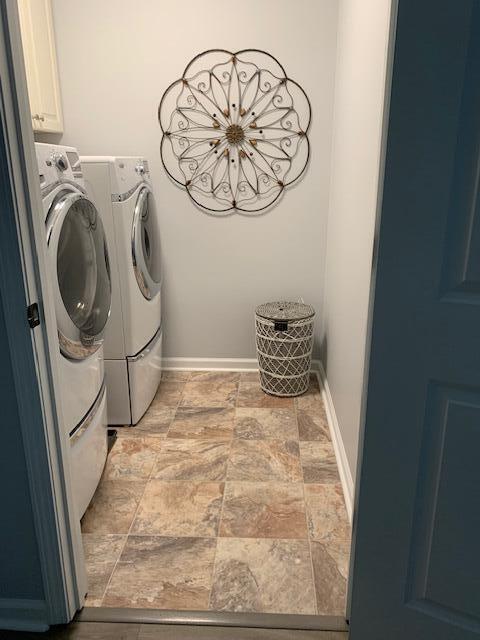 3808 Tupelo Branch Row, Mount Pleasant, SC 29429 - washroom with washing machine and dryer, stone finish floors, and cabinet space