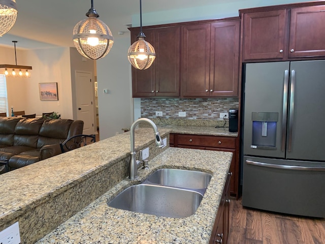 3808 Tupelo Branch Row, Mount Pleasant, SC 29429 - kitchen featuring stainless steel refrigerator with ice dispenser, dark wood-style flooring, decorative light fixtures, decorative backsplash, and light stone countertops