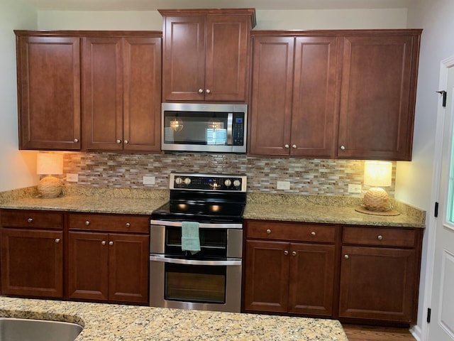 3808 Tupelo Branch Row, Mount Pleasant, SC 29429 - kitchen with appliances with stainless steel finishes, backsplash, and light stone countertops
