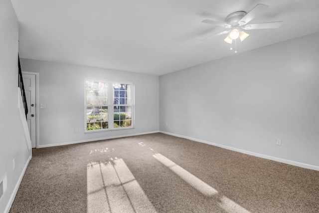 spare room with carpet flooring, baseboards, and a ceiling fan