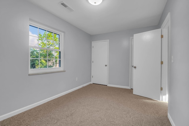 unfurnished bedroom featuring carpet and baseboards