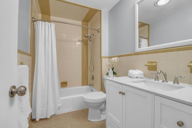 full bathroom featuring tile walls, toilet, shower / bath combo with shower curtain, tile patterned flooring, and vanity