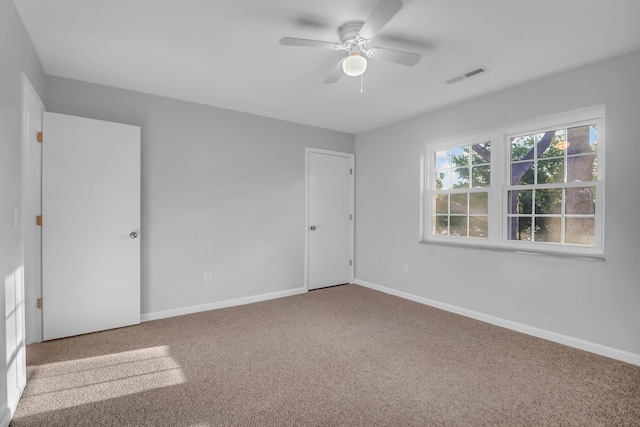 unfurnished bedroom featuring carpet, baseboards, and a ceiling fan