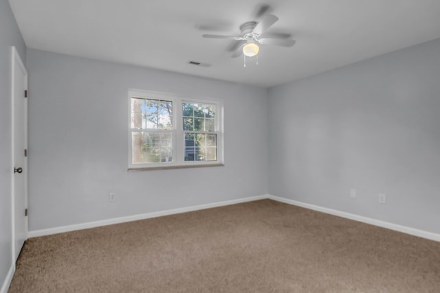 unfurnished room with carpet floors, ceiling fan, and baseboards
