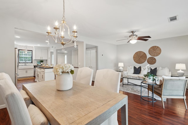 dining room featuring a chandelier, dark wood-style floors, and ceiling fan
