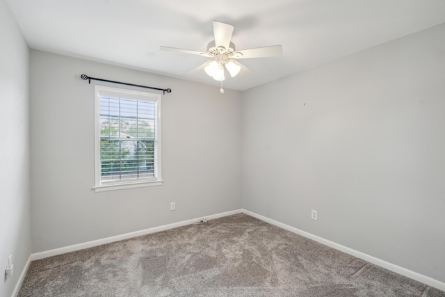 spare room featuring carpet, baseboards, and a ceiling fan