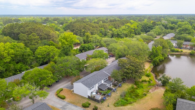 drone / aerial view of a heavily wooded area and a large body of water