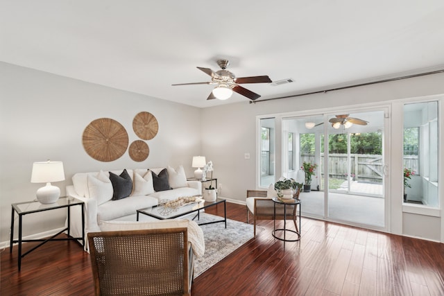 living area featuring a ceiling fan, dark wood-style floors, and baseboards