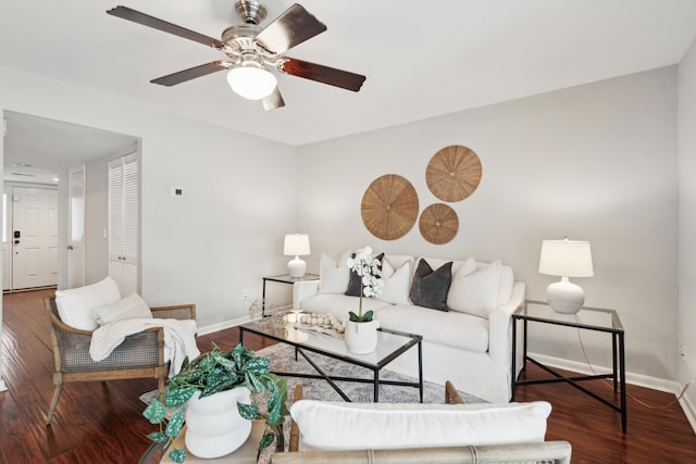 living area featuring wood finished floors, baseboards, and a ceiling fan