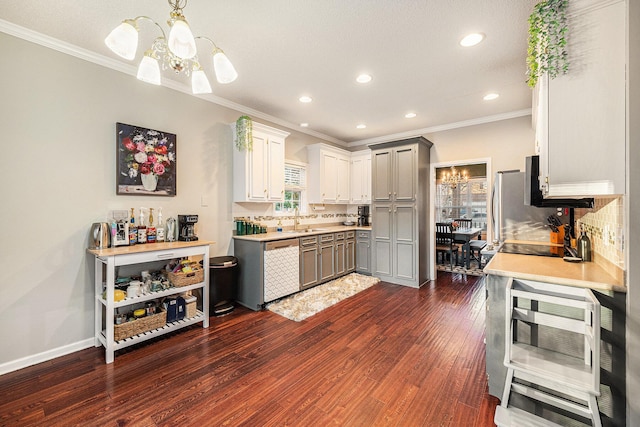 kitchen with dishwasher, gray cabinets, a chandelier, hanging light fixtures, and tasteful backsplash