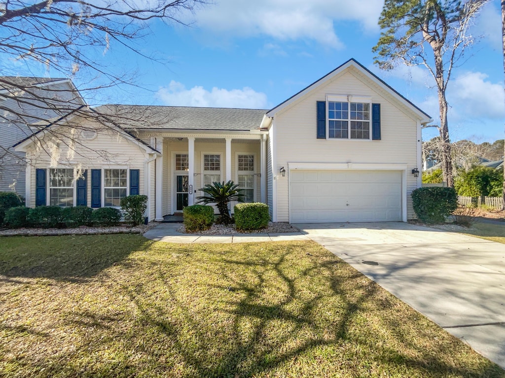 view of front of property with a front yard and a garage