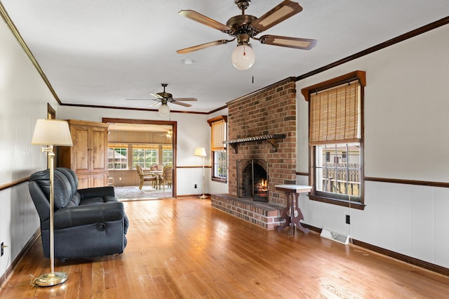 4075 Brown St, Orangeburg, SC 29118 - living area with ceiling fan, crown molding, wood finished floors, a fireplace, and baseboards