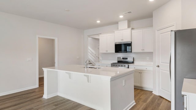 kitchen with stainless steel appliances, sink, a center island with sink, and white cabinets