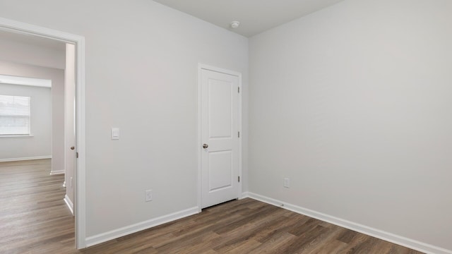 empty room with dark wood-type flooring