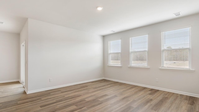 spare room with hardwood / wood-style flooring