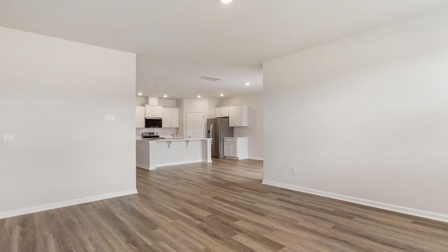 unfurnished living room featuring hardwood / wood-style flooring