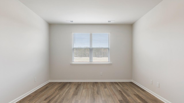 empty room with dark hardwood / wood-style floors