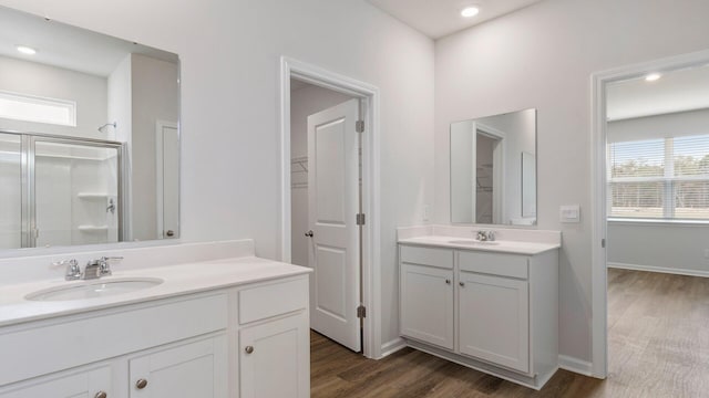 bathroom with vanity, hardwood / wood-style flooring, and walk in shower