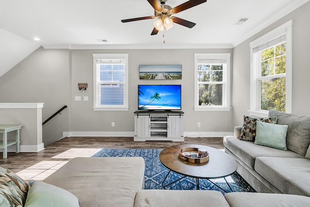 living room featuring lofted ceiling, crown molding, wood-type flooring, and ceiling fan