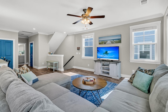 living room featuring ceiling fan, hardwood / wood-style flooring, ornamental molding, and plenty of natural light