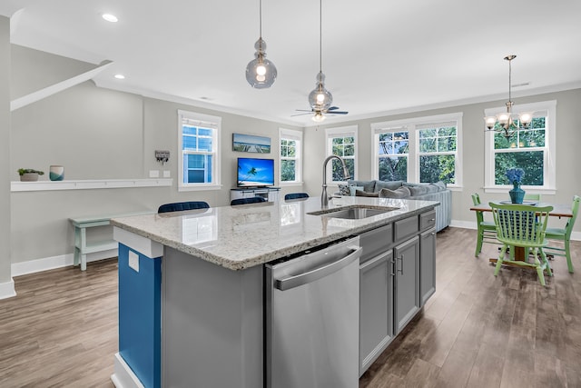 kitchen with a kitchen island with sink, hardwood / wood-style flooring, a wealth of natural light, dishwasher, and sink