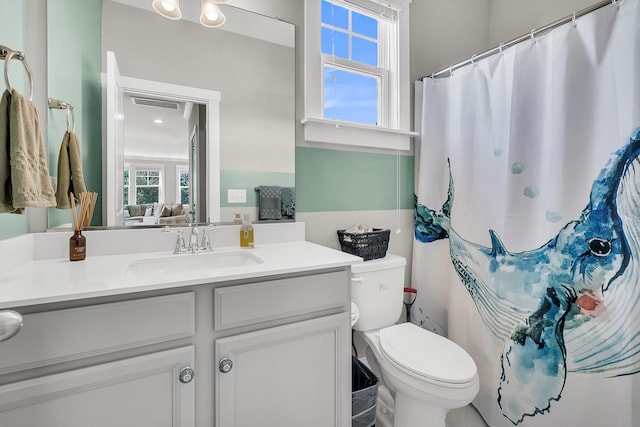 bathroom featuring vanity and toilet