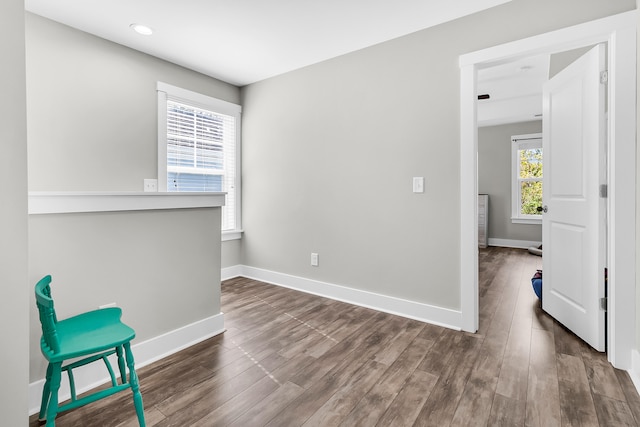 unfurnished room with dark hardwood / wood-style floors and a healthy amount of sunlight