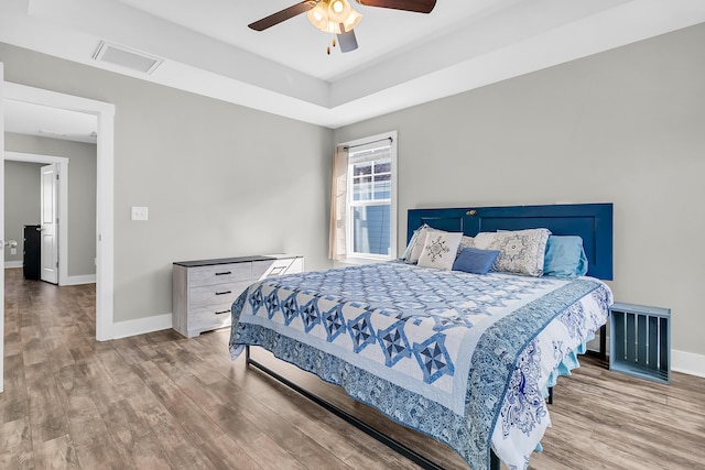 bedroom with ceiling fan and hardwood / wood-style floors