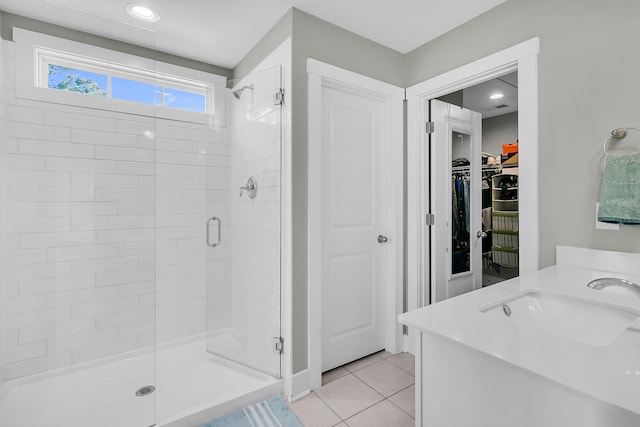 bathroom featuring vanity, tile patterned floors, and a shower with shower door