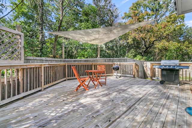 wooden terrace featuring a grill