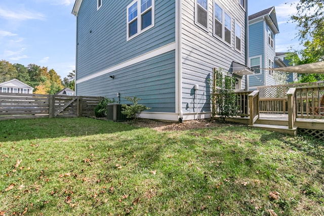 view of yard featuring a wooden deck and central air condition unit