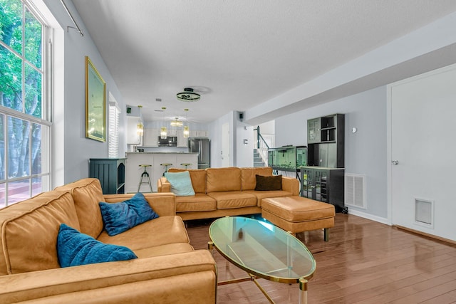 2773 Forest Dew Ct, Charleston, SC 29414 - living room with stairway, wood finished floors, and a textured ceiling