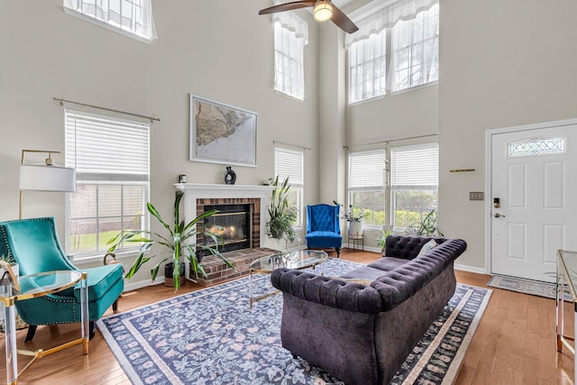2773 Forest Dew Ct, Charleston, SC 29414 - living room with a towering ceiling, wood finished floors, ceiling fan, a fireplace, and plenty of natural light