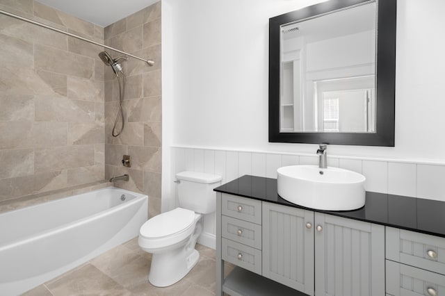 full bathroom with tiled shower / bath combo, vanity, and toilet